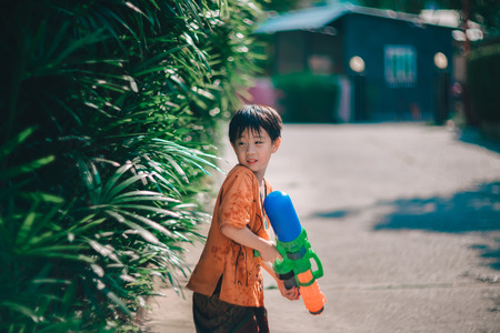 Children playing  Water gun  in Water Festival  Chiang mai Thailandの写真素材