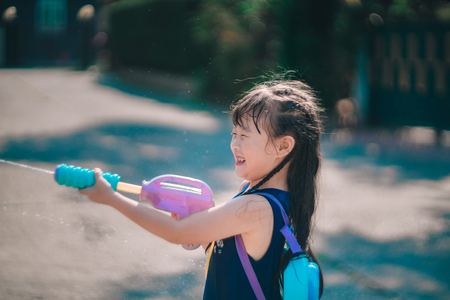 Children playing  Water gun  in Water Festival  Chiang mai Thailandの写真素材