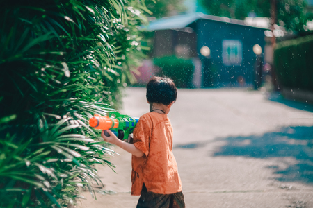 Children playing  Water gun  in Water Festival  Chiang mai Thailandの写真素材