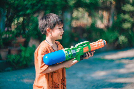 Children playing  Water gun  in Water Festival  Chiang mai Thailandの写真素材