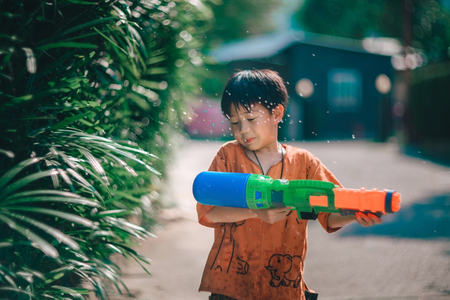 Children playing  Water gun  in Water Festival  Chiang mai Thailandの写真素材