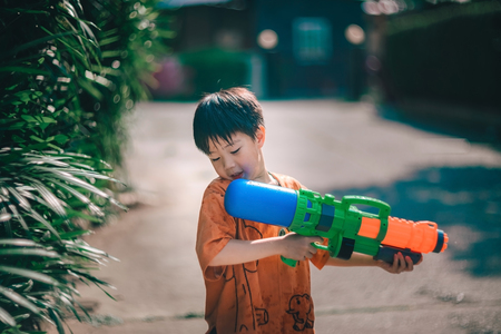 Children playing  Water gun  in Water Festival  Chiang mai Thailandの写真素材