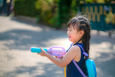 Children playing  Water gun  in Water Festival  Chiang mai Thailandの写真素材