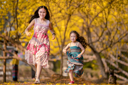 happy children in yellow flower fieldの写真素材