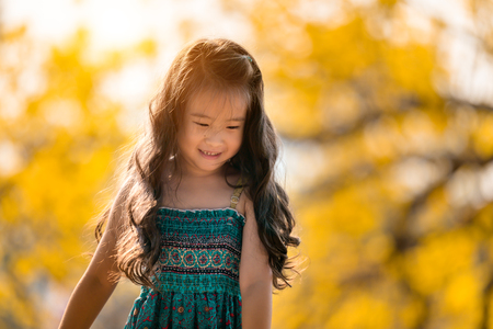 happy children in yellow flower fieldの写真素材