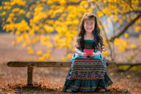 happy children in yellow flower fieldの写真素材