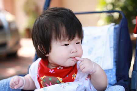 Cute asian Baby in a strollerの写真素材