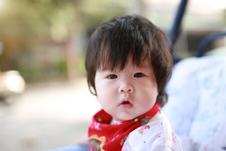Cute asian Baby in a strollerの写真素材
