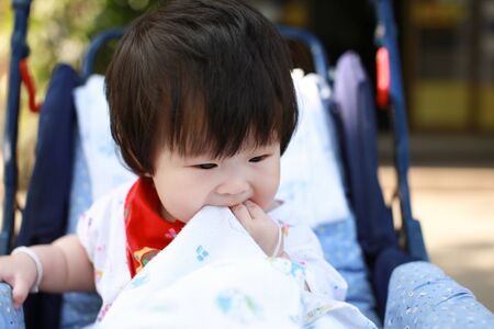 Cute asian Baby in a strollerの写真素材