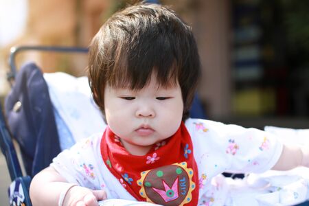 Cute asian Baby in a strollerの写真素材
