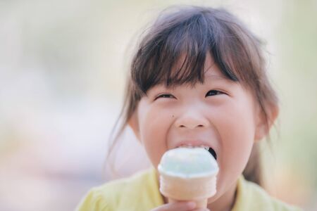 Asian little girl eating icecreamの写真素材