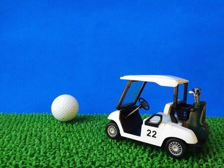 Golf ball and golf cart on golf course.の素材
