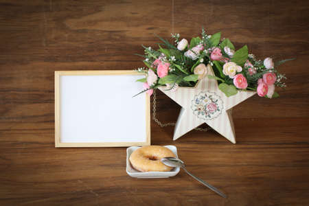 wooden frame and donut with colorful floralの写真素材