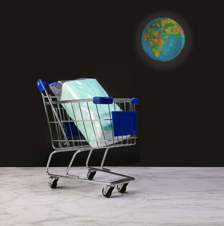 Surgical masks in shopping cart for save the worldの写真素材