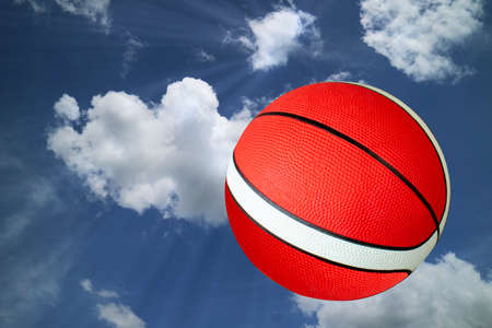classic baskketball on cloud sky with light ray backgroundの写真素材
