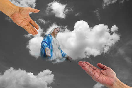 helping hand and hands together with Mary in white clouds with light ray background ,  Two hands...