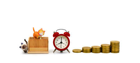 the empty wooden calendar and a classic alarm clock stands next to a pile of coin and the time shows...
