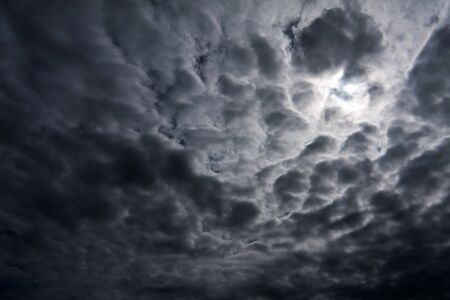 Sky filled with bad weather dark thunderstorm clouds filled with rain.の写真素材
