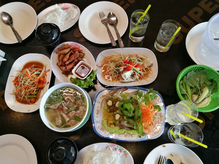 Famous Thai food, Spicy Shrimp Soup with Tom Yam ,Papaya salad with fried chicken on wood tableの写真素材