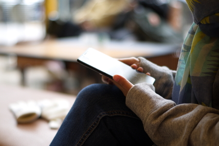 Business women hand are using smartphone in a cafe,blurred and soft focus imageの写真素材