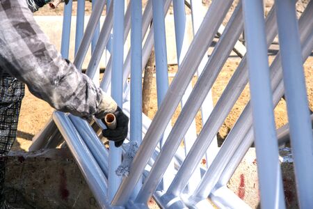 labor was painting white color to carbon steel on site constructionの写真素材