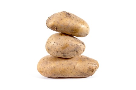 Stack of potatoes isolated on white backgroundの写真素材