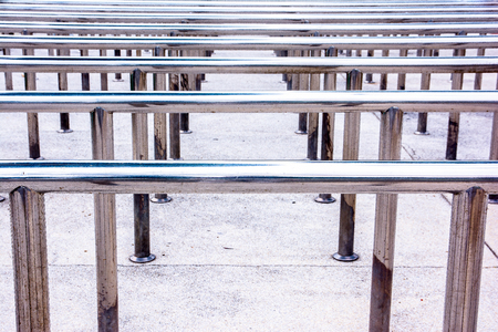Row of metal hand handrails background in the parkの写真素材
