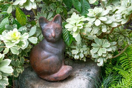 Ceramic cat doll sitting decorative in the parkの写真素材