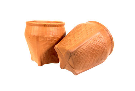 Two clay pot in weave wooden style isolated on white backgroundの写真素材