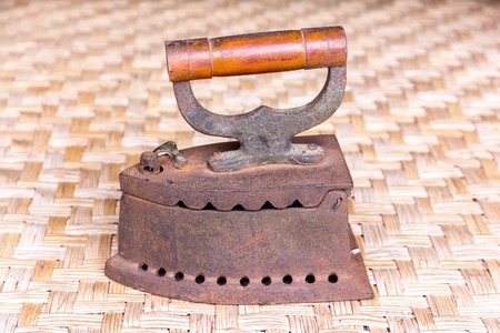 Old iron on rattan weave mat