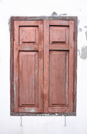 Old wooden windows on concrete white wallの写真素材