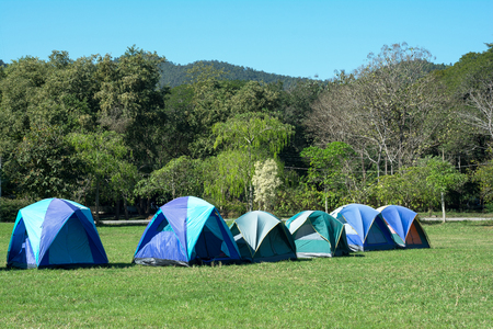 Tourist tent in forest camp among meadow.Tent camping among the hillの写真素材