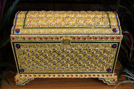 Treasure chest gold on the table.Thai gold treasure chest.Treasure boxの写真素材