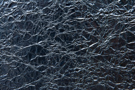 Dark silver rough foil texture background.Black silver textured