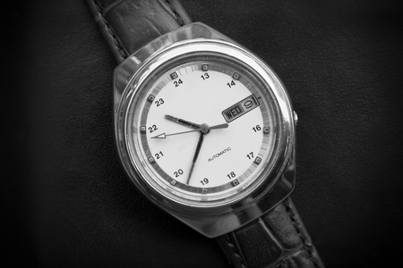 Black and white retro men wrist watch on black leather background.Old men wrist watchの写真素材