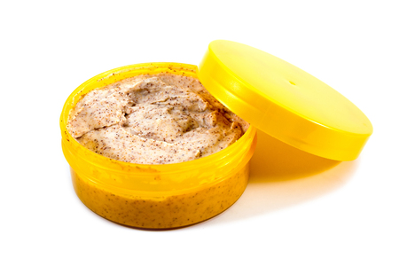 Open cosmetic cream bottle with can lid isolated on white backgroundの写真素材