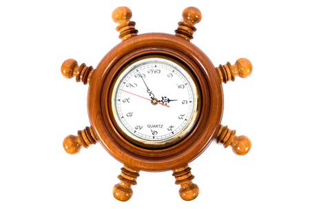 Wooden wall clock with Thailand numeric and ship steering shape isolated on white background.の写真素材
