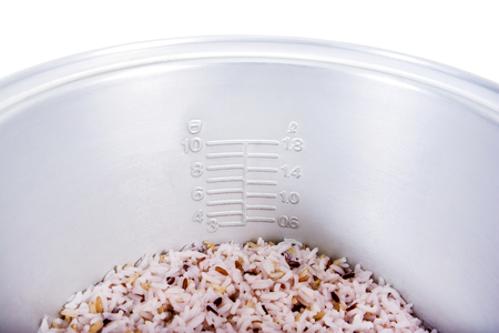 Closeup of electric rice cooker inner with scale and cooked rice texture backgroundの写真素材