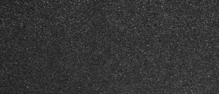 Panorama black sandpaper texture background. Panoramic dark black sandpaper texture surfaceの写真素材