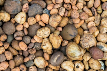 Round brown pebbles texture background. Nature round brown color pebbles surface
