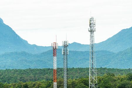 Closeup of telecommunication tower antenna with mountain background. Various of mobile telephone...