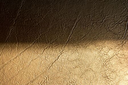 Two tone brown gold leather texture with shadow background. Half dark and bright gold leather...