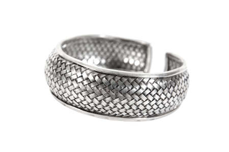 Silver bracelet isolated on white background. Thick silver bracelet or armlet with weave pattern...