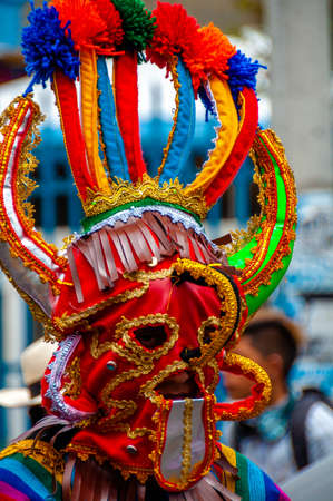 Man with traditional colorful mask parading down the streetの写真素材