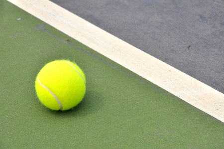 Tennis ball on a tennis courtの写真素材