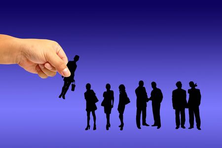 Silhouettes of people on hand in the world backgroundの写真素材