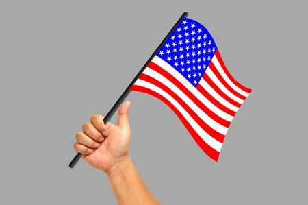 Hand holding America flag isolated on white backgroundの写真素材