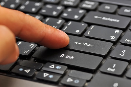 Finger on computer keyboard at enter keyの写真素材