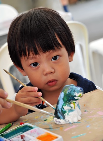 Child 2 years painting in preschoolの写真素材