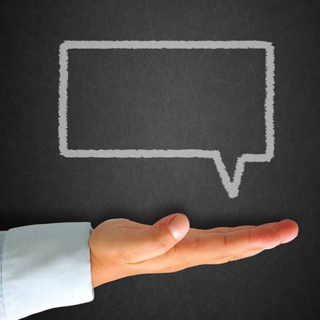 Think bubble blank written on blackboard with handの写真素材